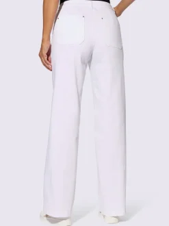 Jean à jambes larges en coton avec œillets et rivets décoratifs
