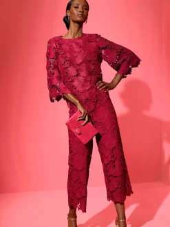 Pantalon en dentelle à motif floral et ourlet scallé